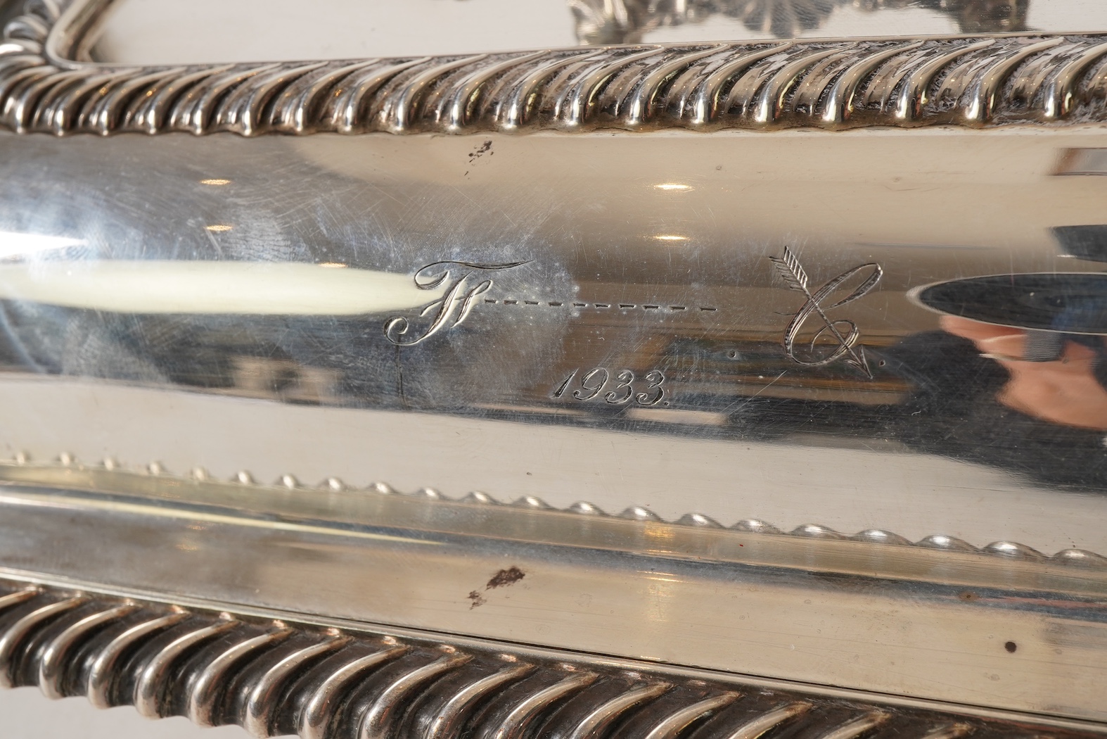 A matched pair of George V silver rectangular entrée dishes and covers, both with gadrooned borders and similar unmarked handles, Ellis & Co, Birmingham, 1923 and Ellis & Co, Birmingham, 1932, base 27.8cm, 108.3oz, exclu